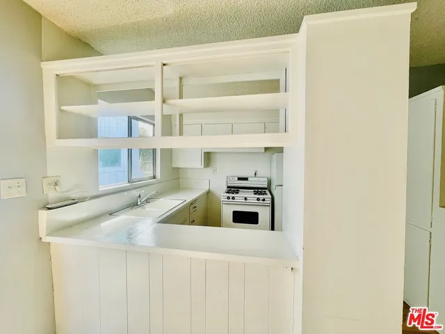 a kitchen with stainless steel appliances a refrigerator and a sink