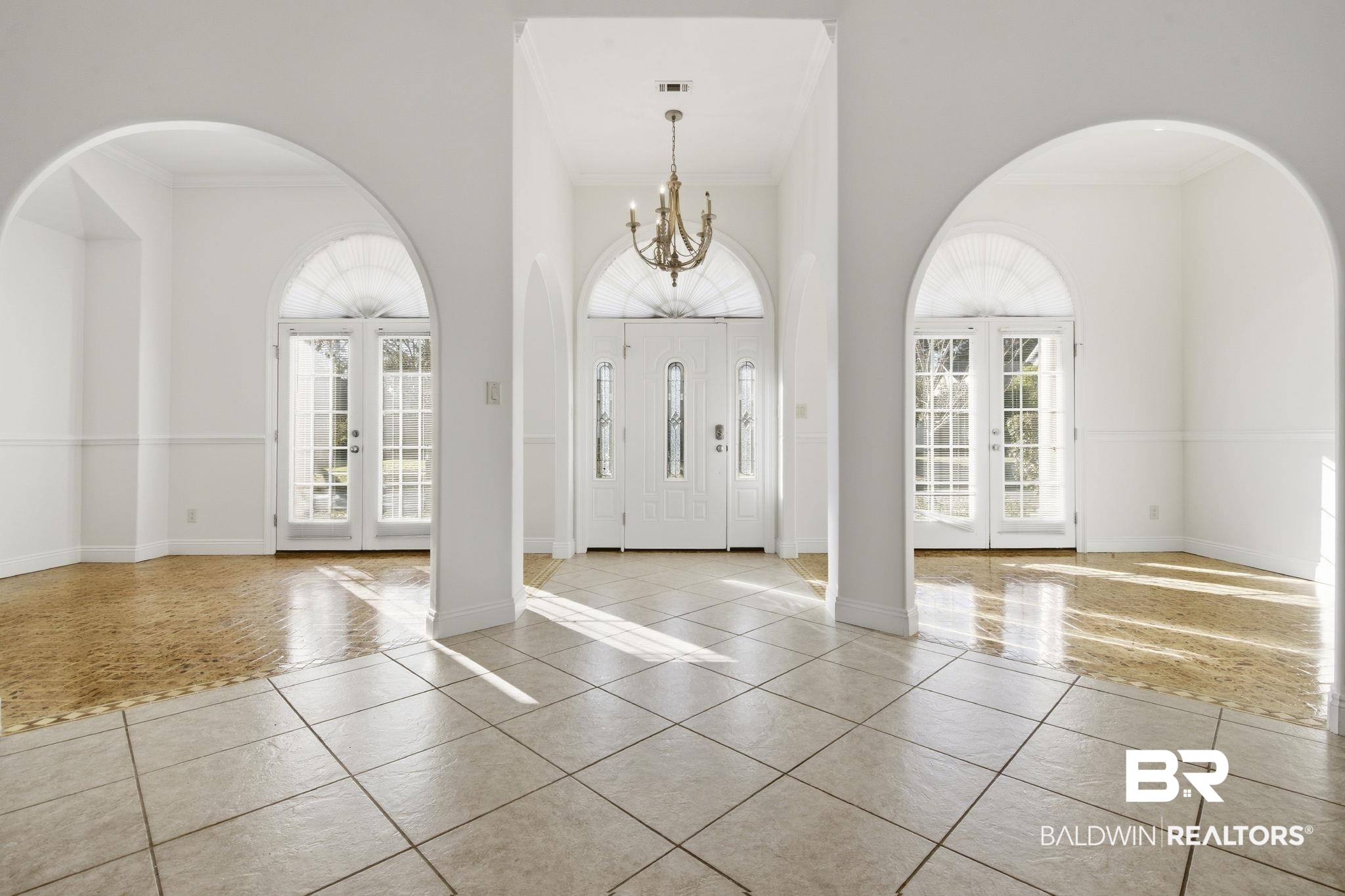 29634 St George Street Daphne, AL 36526 - Photo 9 of 47 Tiled entrance foyer featuring french doors, arched walkways, crown molding, and a chandelier