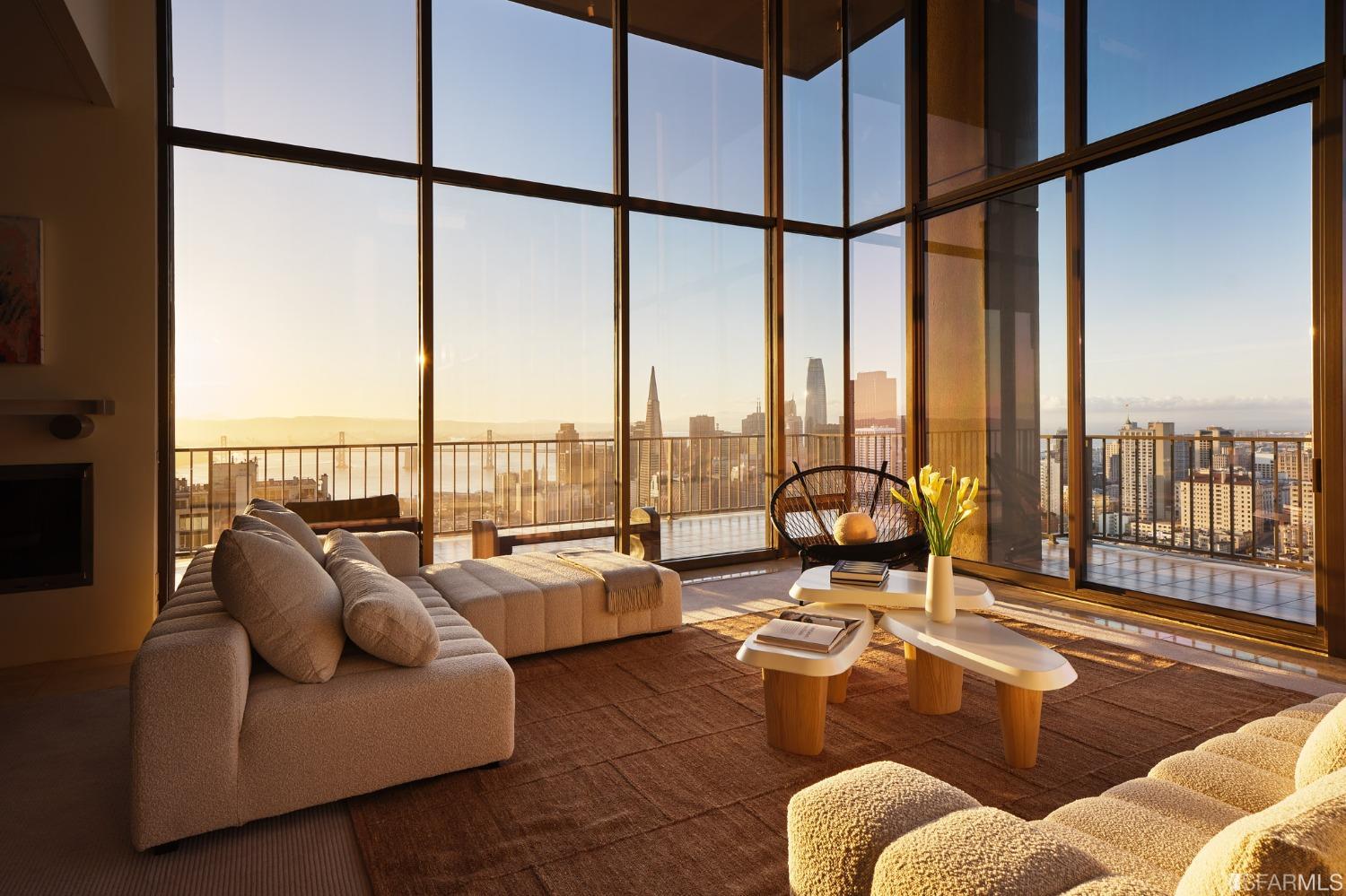 a living room with furniture and floor to ceiling windows