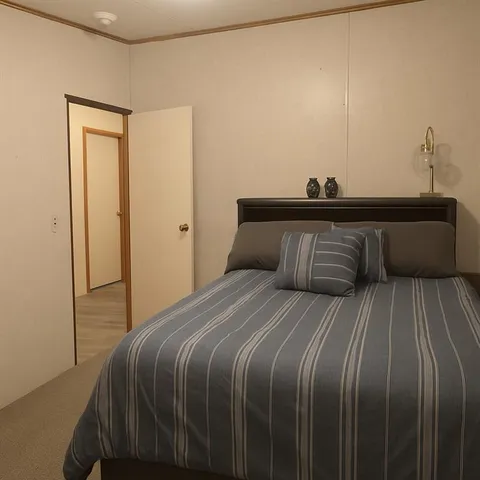 a white toilet sitting next to a white sink and vanity