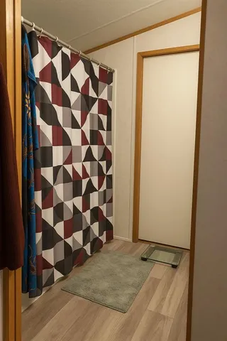 a view of a chairs and table in patio with wooden floor