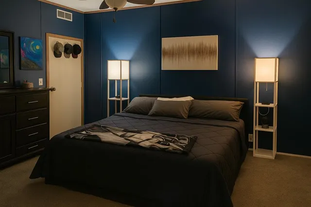 a bedroom with a bed and a mirror on dresser