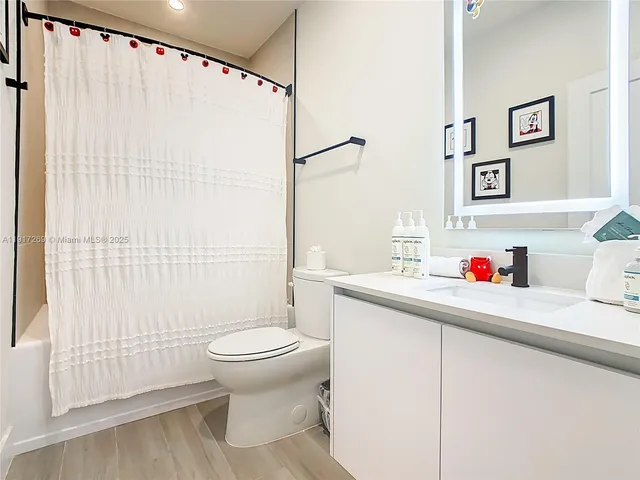 a bathroom with a sink toilet and shower
