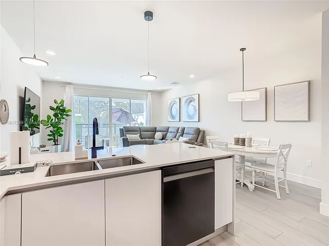 a kitchen with a sink and chairs