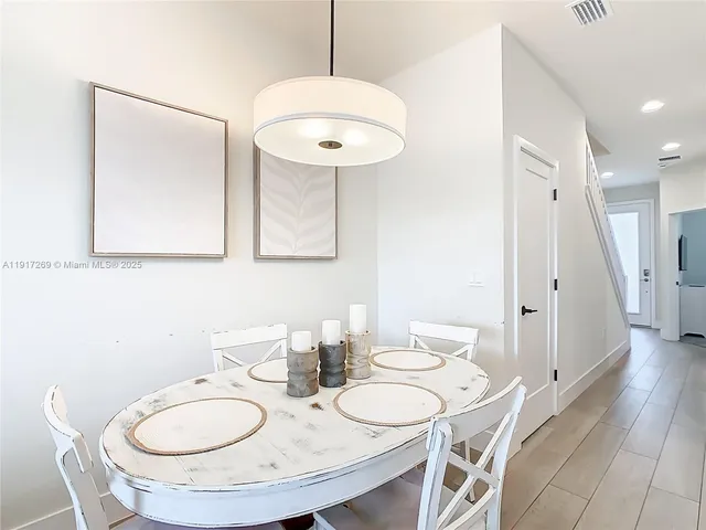 a view of a dining room with furniture wooden floor and chandelier
