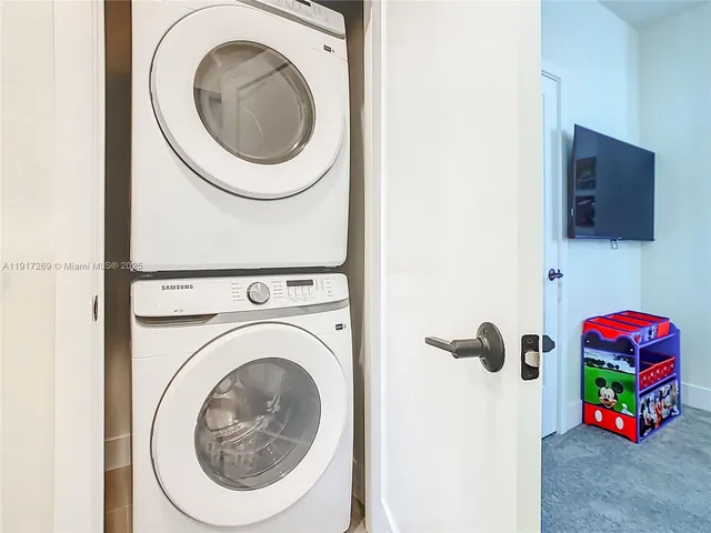 a living room with furniture and flat screen tv