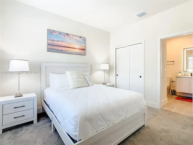 a bedroom with a bed and a night stand