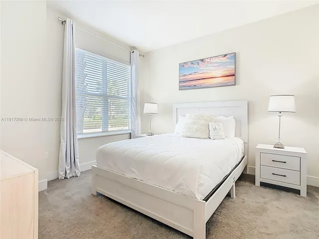 a bedroom with a bed and a night stand