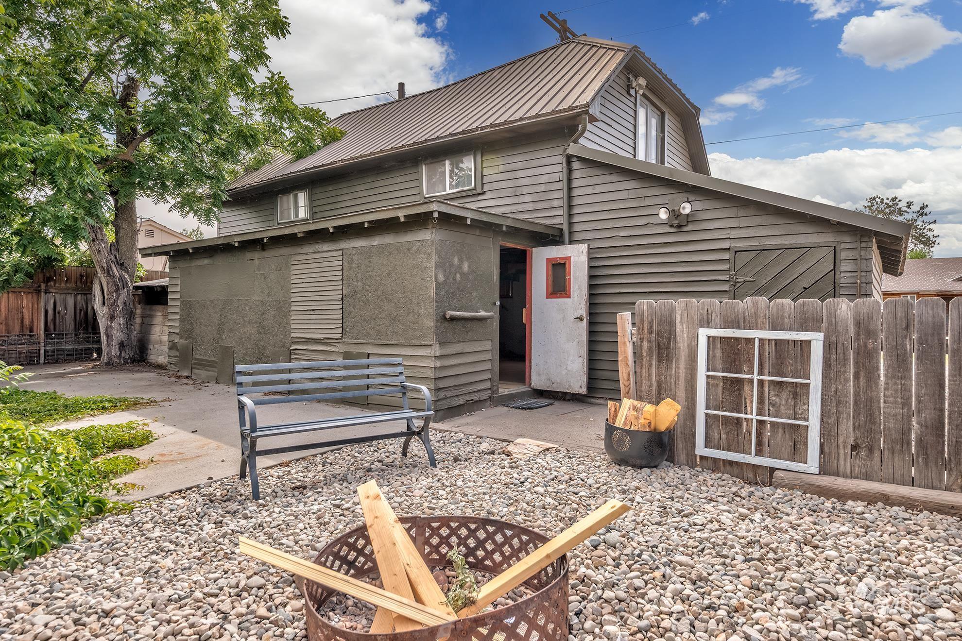 61 Southwest 4th Street Ontario, OR 97914 - Photo 37 of 42 Rear exterior featuring wood siding, a metal roof, and a concrete patio