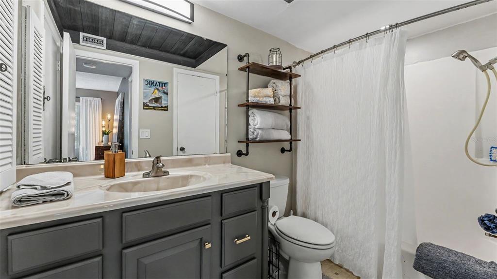 2025 Sylvester Road, Unit N305 Lakeland, FL 33803 - Photo 18 of 34 a bathroom with a granite countertop sink toilet and shower