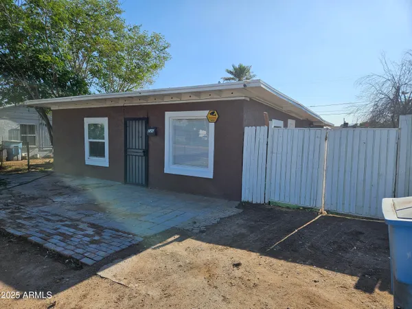 a view of a house with a small backyard