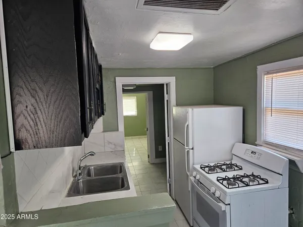 a kitchen with refrigerator and window