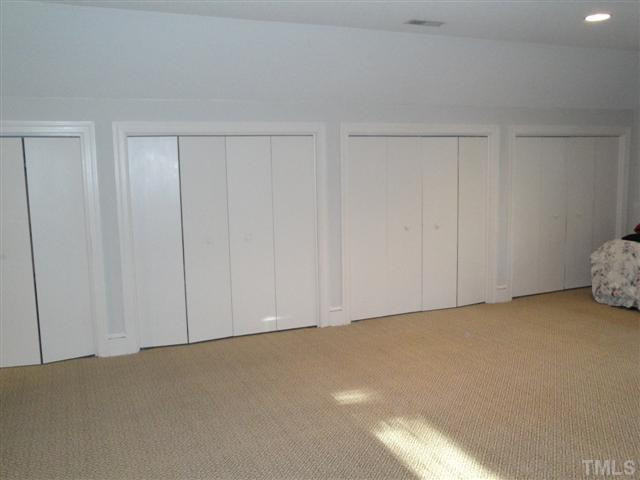 10209 Whitestone Road Raleigh, NC 27615 - Photo 15 of 25 Wall of closets in bonus room for extra storage Bonus Room
