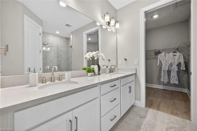 a bathroom with a double vanity sink and a mirror