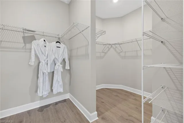 a view of walk in closet with empty racks