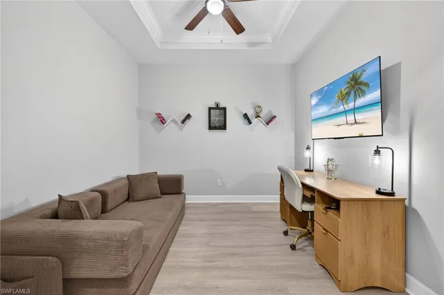 a living room with furniture and wall paintings