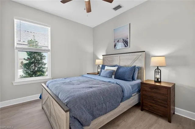 a bedroom with a bed and a night stand