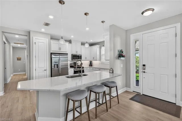 a kitchen with stainless steel appliances kitchen island granite countertop a refrigerator and a stove top oven