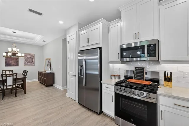 a kitchen with stainless steel appliances a stove a microwave and a refrigerator