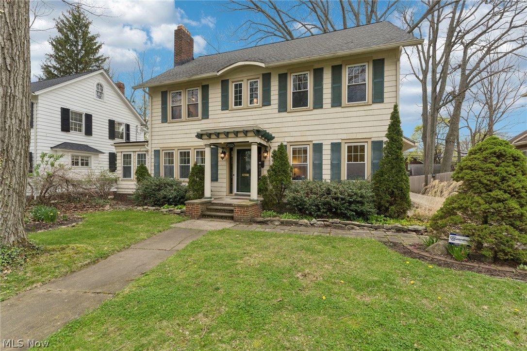 2925 East Overlook Road Cleveland Heights, OH 44118 - Photo 1 of 48 The property features a traditional facade with shutters and a covered entry, set against a well-maintained lawn and mature trees