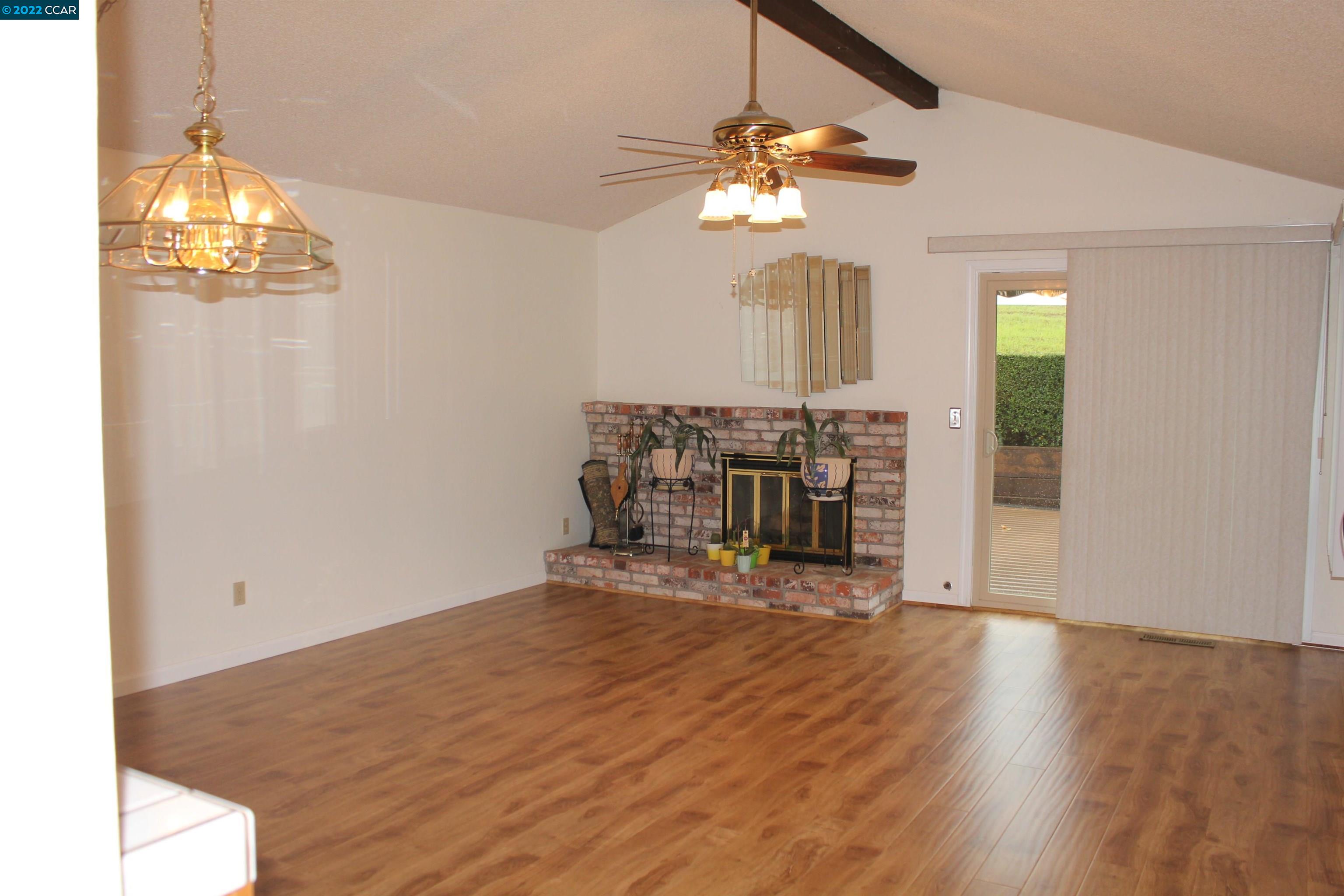 5328 Paso Del Rio Way Concord, CA 94521 - Photo 4 of 22 a view of a room with wooden floor fireplace and chandelier