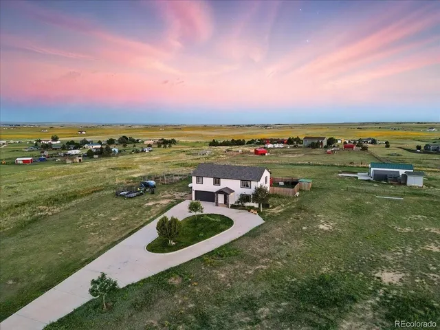 a view of a city with lawn chairs and a fire pit