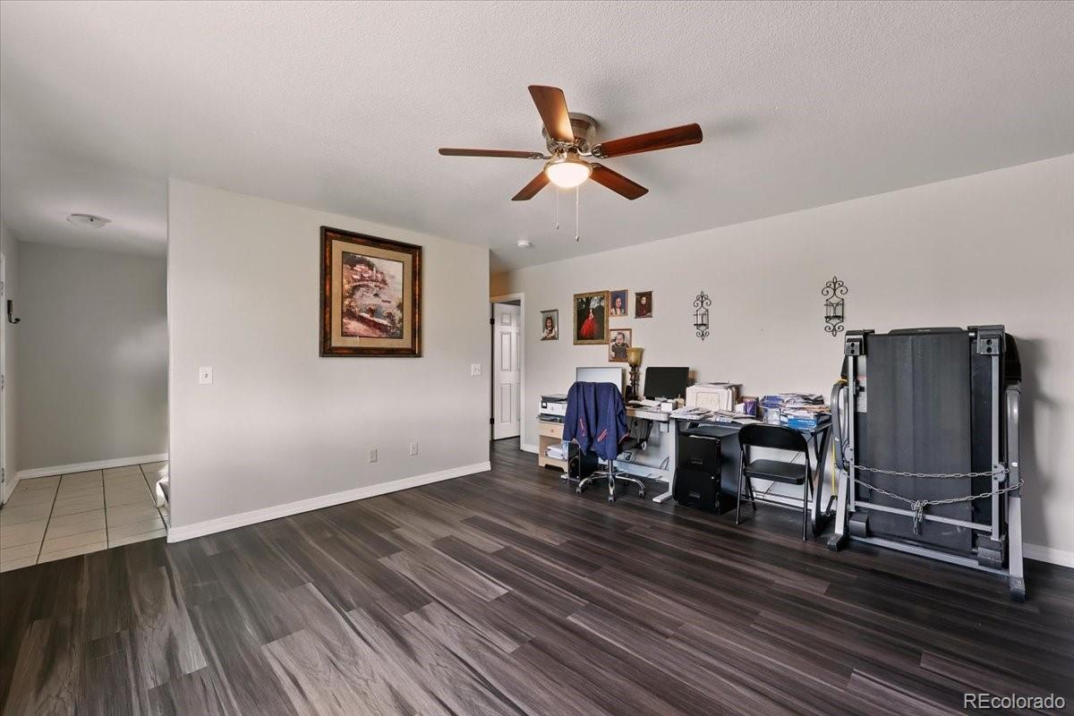 17435 Wagon Train Loop Peyton, CO 80831 - Photo 13 of 40 a view of a workspace with wooden floor