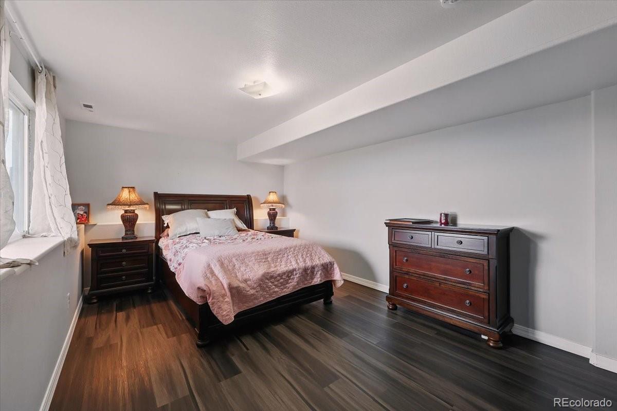 17435 Wagon Train Loop Peyton, CO 80831 - Photo 16 of 40 a bedroom with a bed and wooden floor