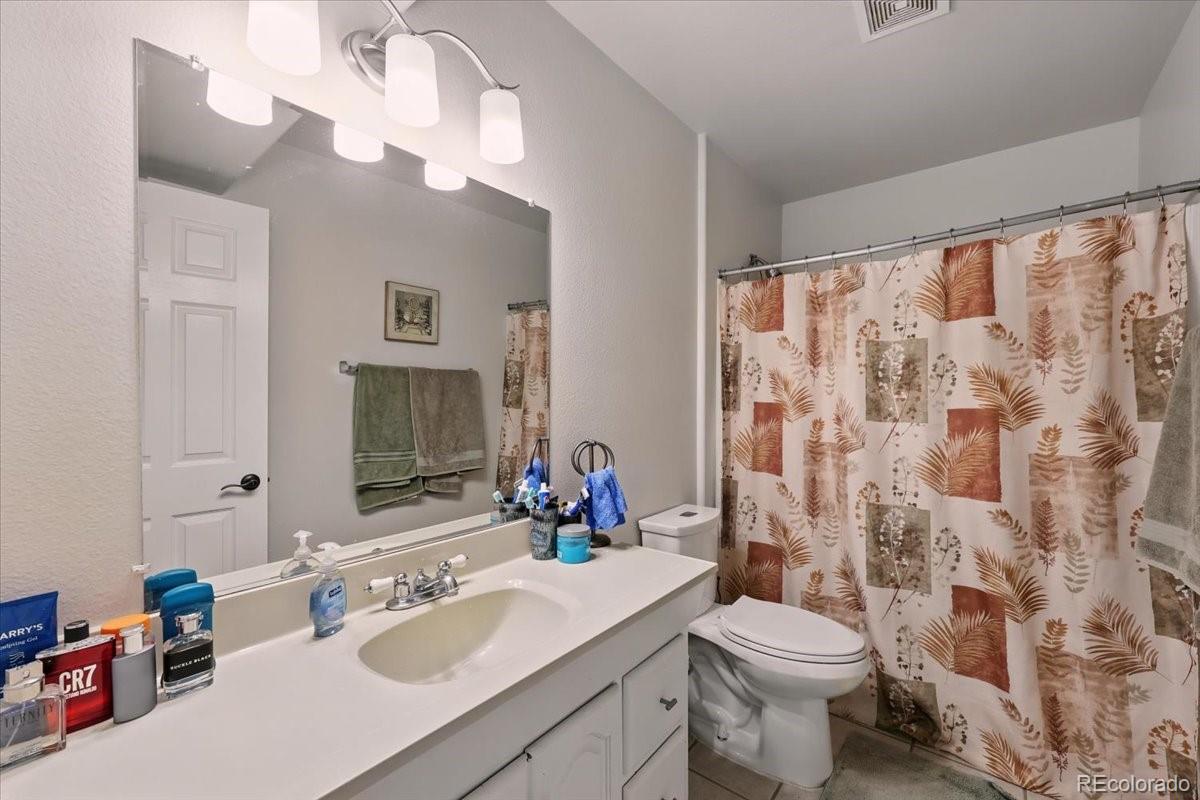 17435 Wagon Train Loop Peyton, CO 80831 - Photo 19 of 40 a bathroom with a sink vanity mirror and toilet