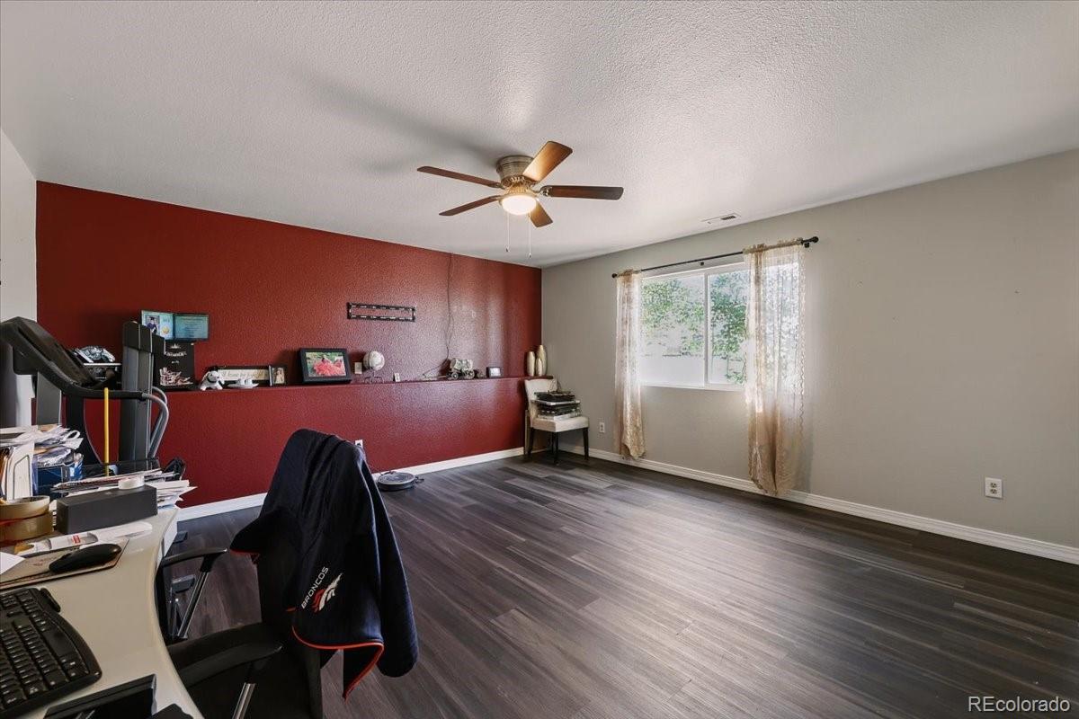 17435 Wagon Train Loop Peyton, CO 80831 - Photo 20 of 40 a view of a livingroom with furniture chandelier fan and windows