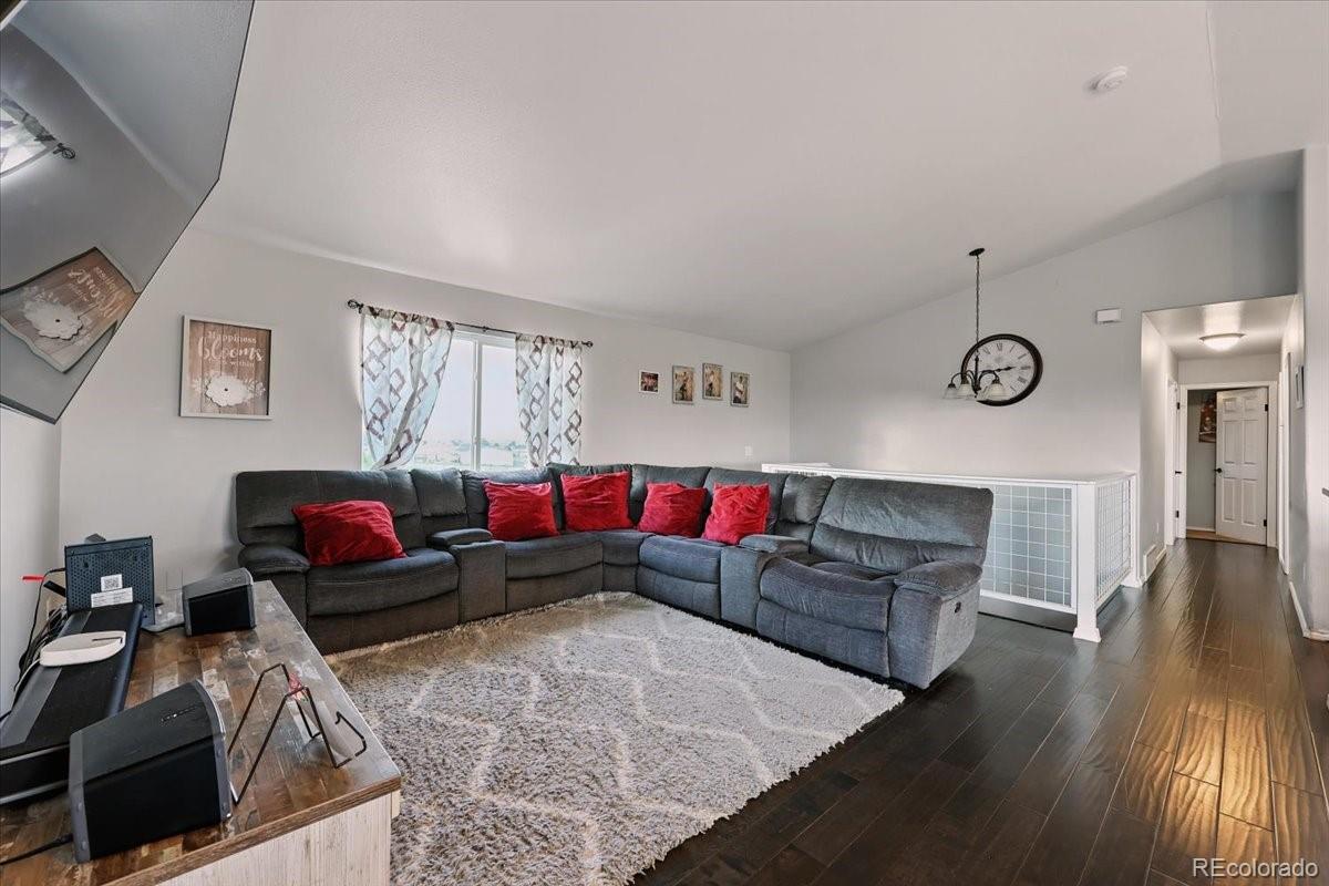 17435 Wagon Train Loop Peyton, CO 80831 - Photo 23 of 40 a living room with furniture and wooden floor