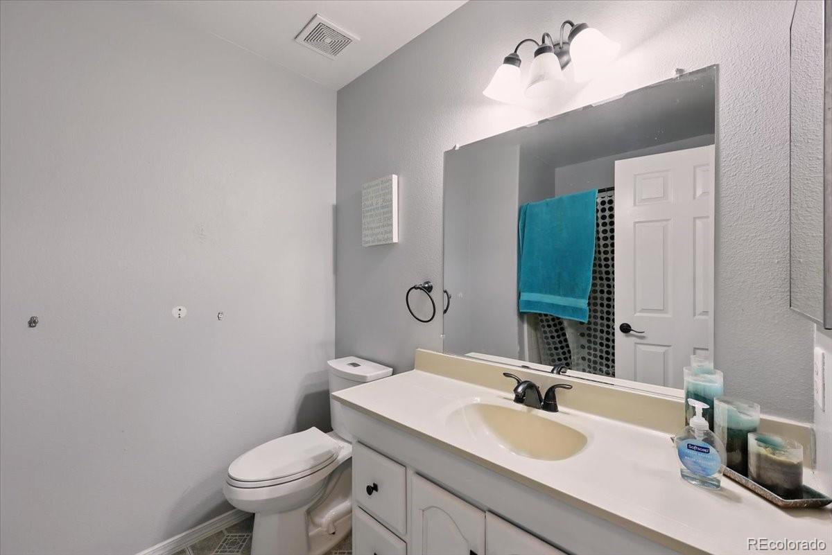 17435 Wagon Train Loop Peyton, CO 80831 - Photo 24 of 40 a bathroom with a sink a toilet and mirror