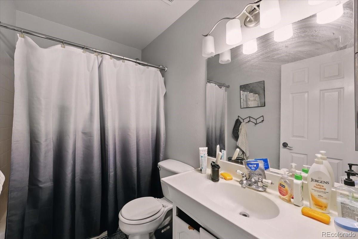 17435 Wagon Train Loop Peyton, CO 80831 - Photo 32 of 40 a bathroom with a sink a toilet and a mirror