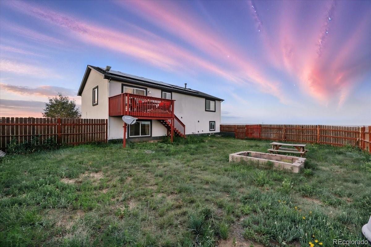 17435 Wagon Train Loop Peyton, CO 80831 - Photo 33 of 40 a front view of a house with garden