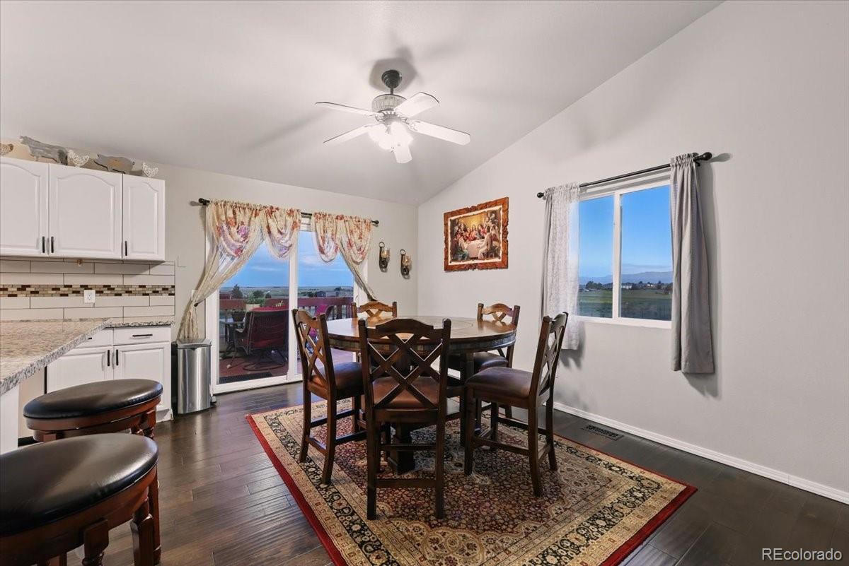 17435 Wagon Train Loop Peyton, CO 80831 - Photo 6 of 40 a view of a dining room with furniture and wooden floor