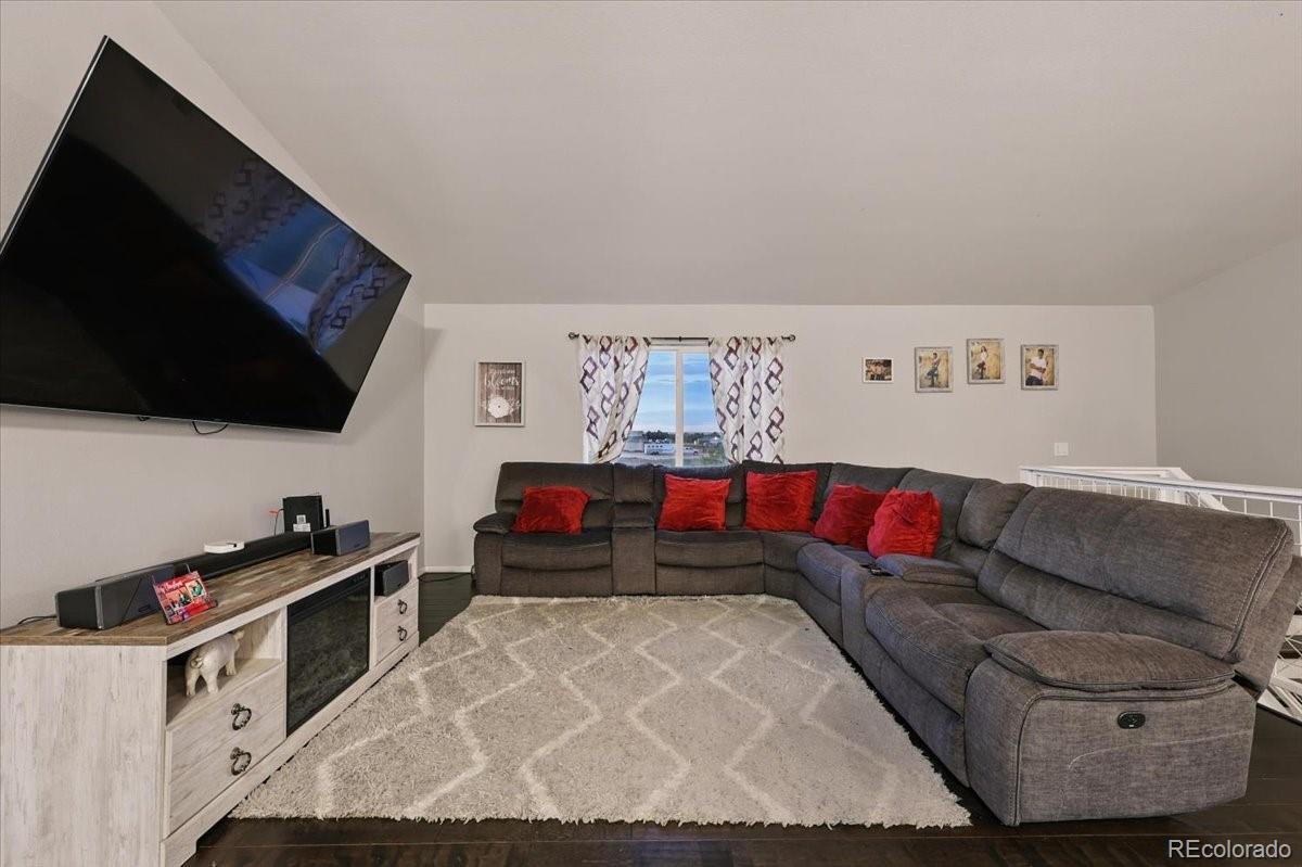 17435 Wagon Train Loop Peyton, CO 80831 - Photo 9 of 40 a living room with furniture and a flat screen tv