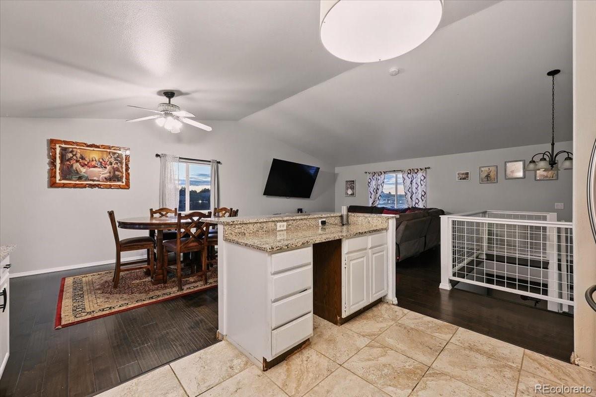 17435 Wagon Train Loop Peyton, CO 80831 - Photo 10 of 40 a view of a livingroom with furniture and a kitchen
