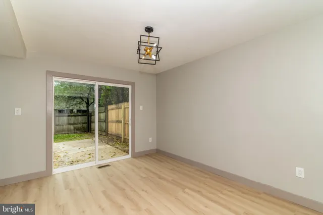 a view of an empty room with glass door