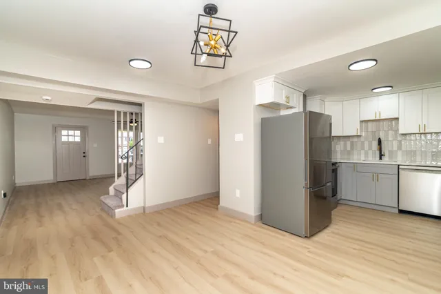 a view of empty room with wooden floor and window