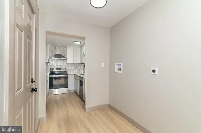 a kitchen with a refrigerator and a stove