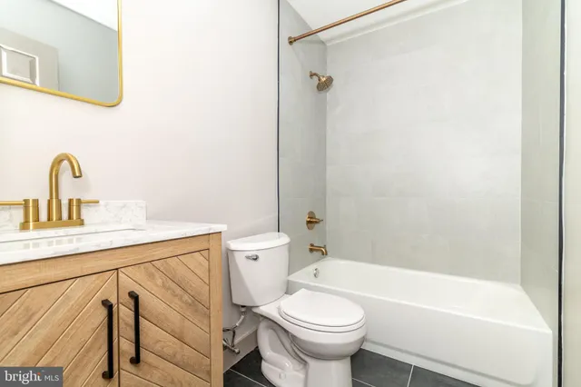 a bathroom with a sink a toilet and a bathtub