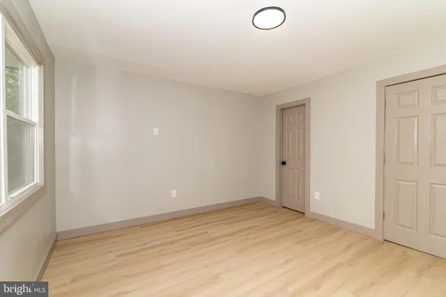 an empty room with a empty space and windows