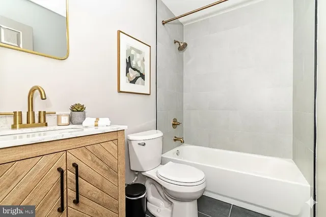 a bathroom with a sink a toilet and a bathtub