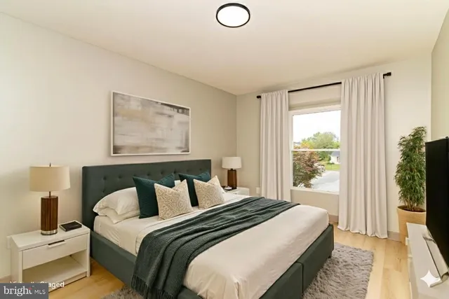 a bedroom with a bed and a large window