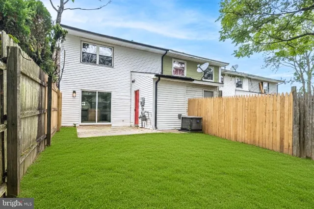 a view of a house with a yard and garage