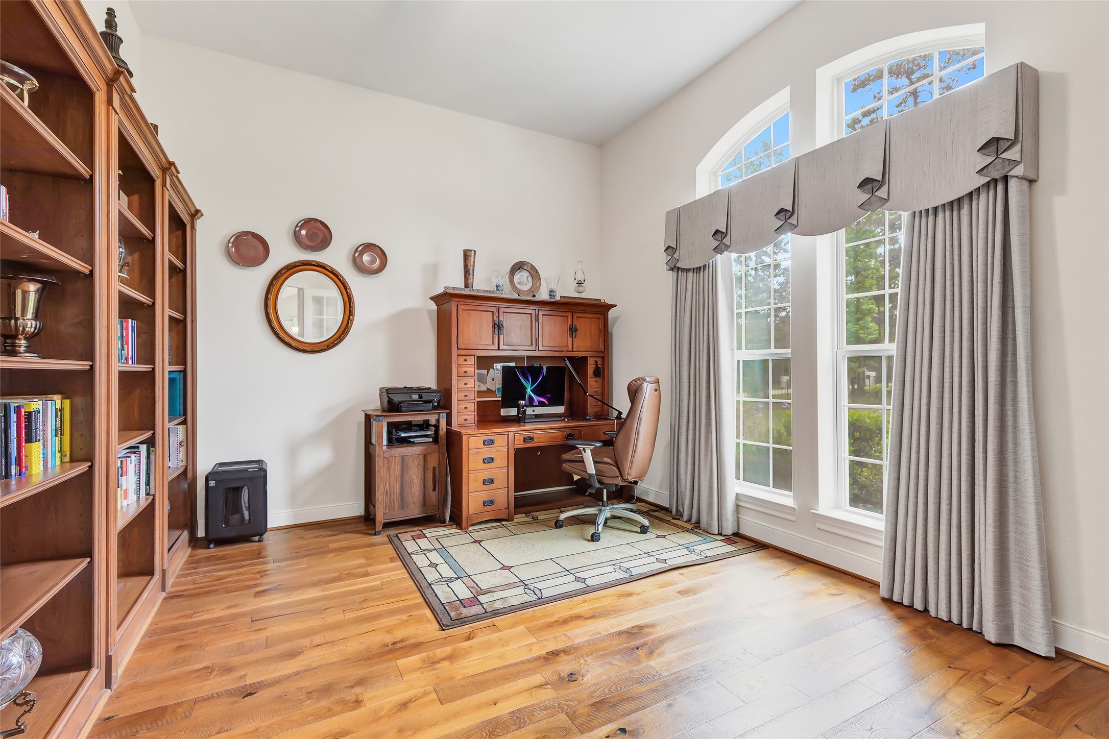 229 Sundog Road Huntsville, TX 77340 - Photo 11 of 50 The oversized study. Notice the built in book cases. These windows offer a supply of natural light and faces the front of the property.