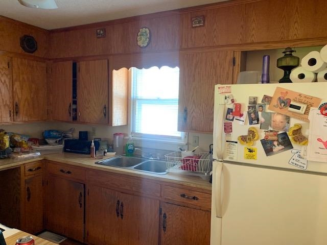 2251 Old Stage Road Adamsville, TN 38310 - Photo 15 of 17 a kitchen with a sink a stove and cabinets