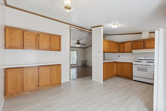 a kitchen with stainless steel appliances granite countertop a stove and a refrigerator
