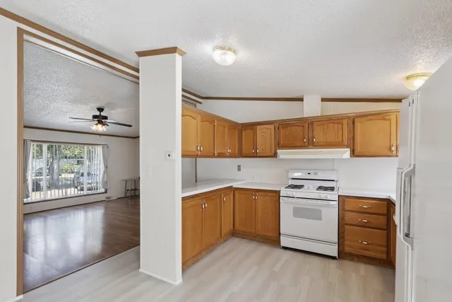 a kitchen with a stove a sink and a window