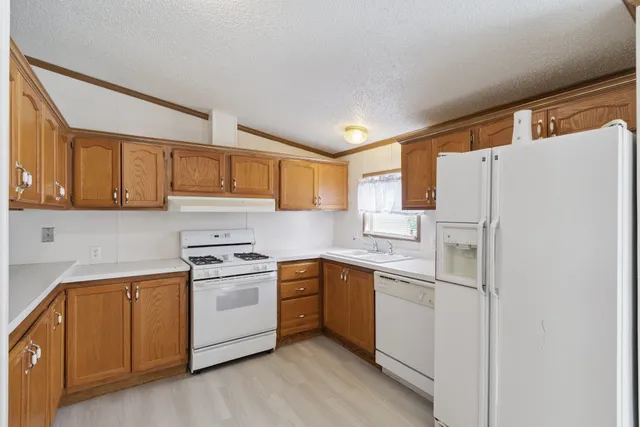 a kitchen with a white cabinets and white appliances